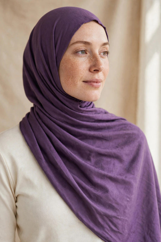 Model wearing the Amethyst Purple premium jersey hijab styled with a cream top - Concealed Muslimah