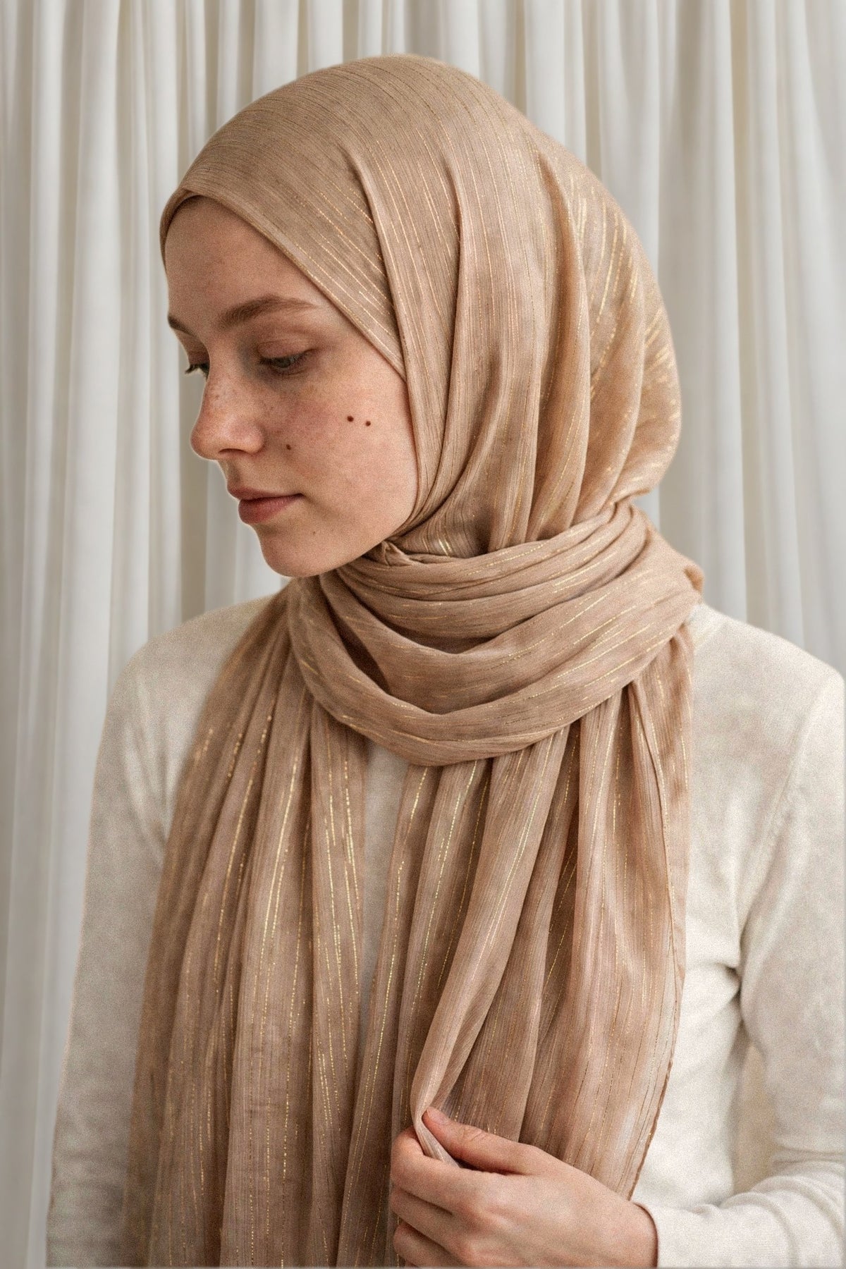 Model wearing the Beige Gold timeless edition hijab styled with a white top - Concealed Muslimah