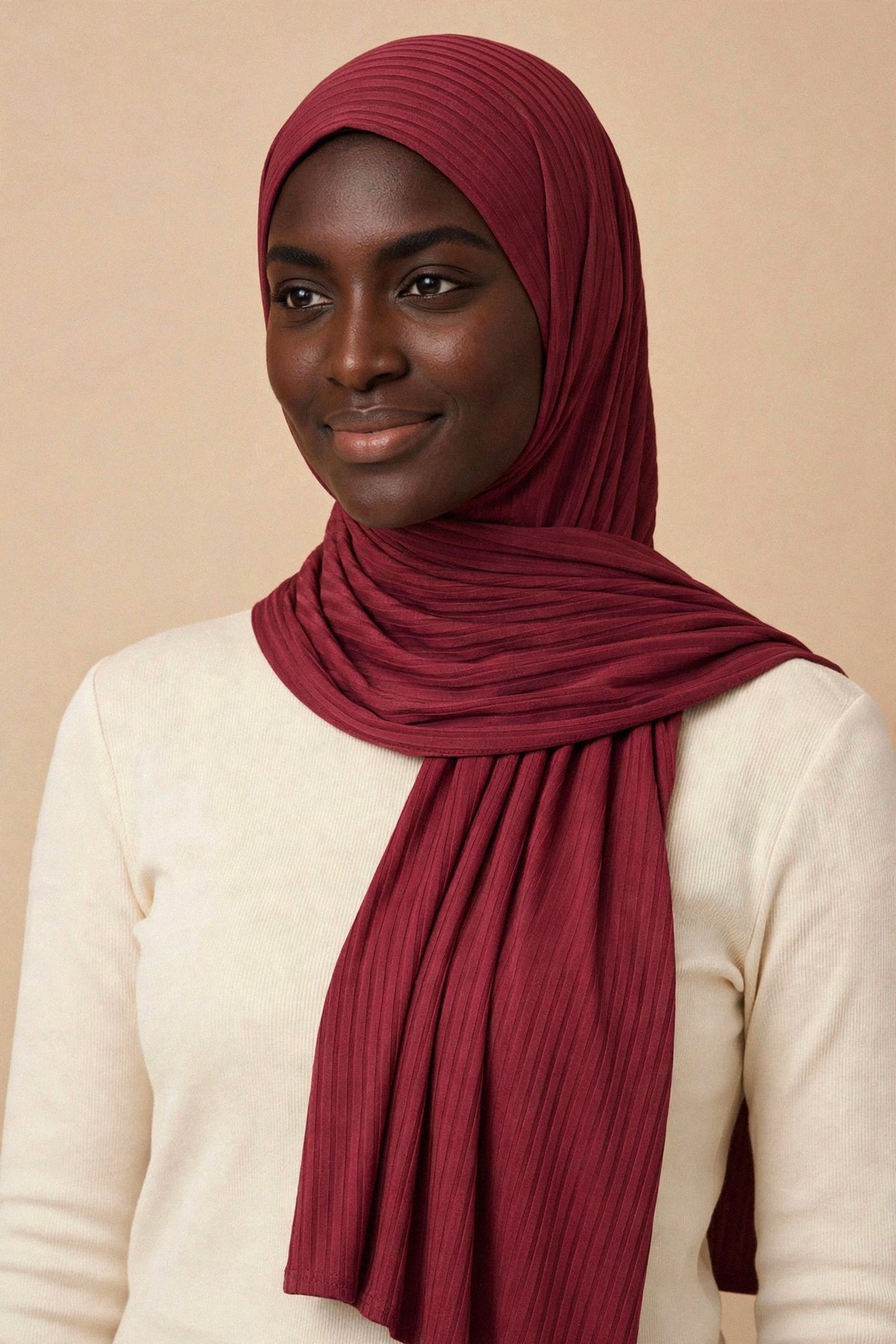 Model wearing the Berry ribbed jersey hijab styled with a cream top - Concealed Muslimah