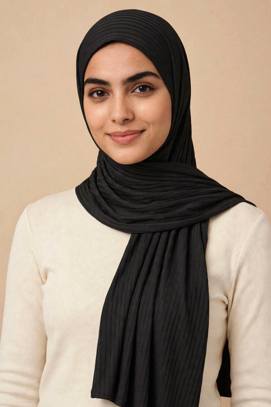 Model wearing the Black ribbed jersey hijab styled with a cream top - Concealed Muslimah