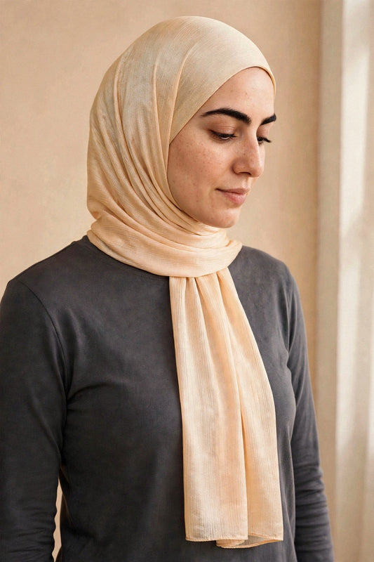 Model wearing the Champagne chrome hijab styled with a charcoal top - Concealed Muslimah