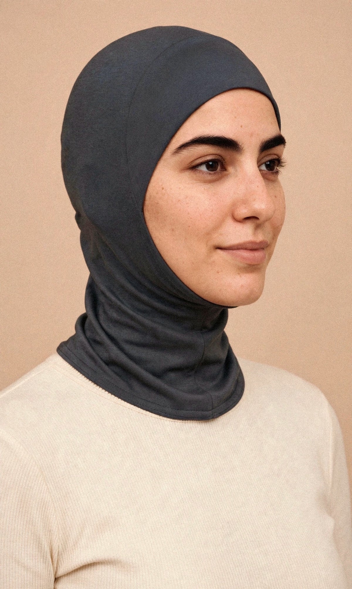 Charcoal Grey - Ninja Underscarf worn by a model — three-quarter view