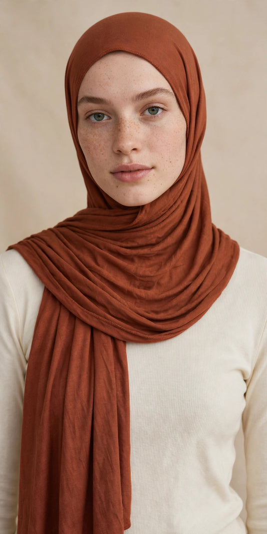 Model wearing the Cinnamon premium jersey hijab styled with a cream top - Concealed Muslimah