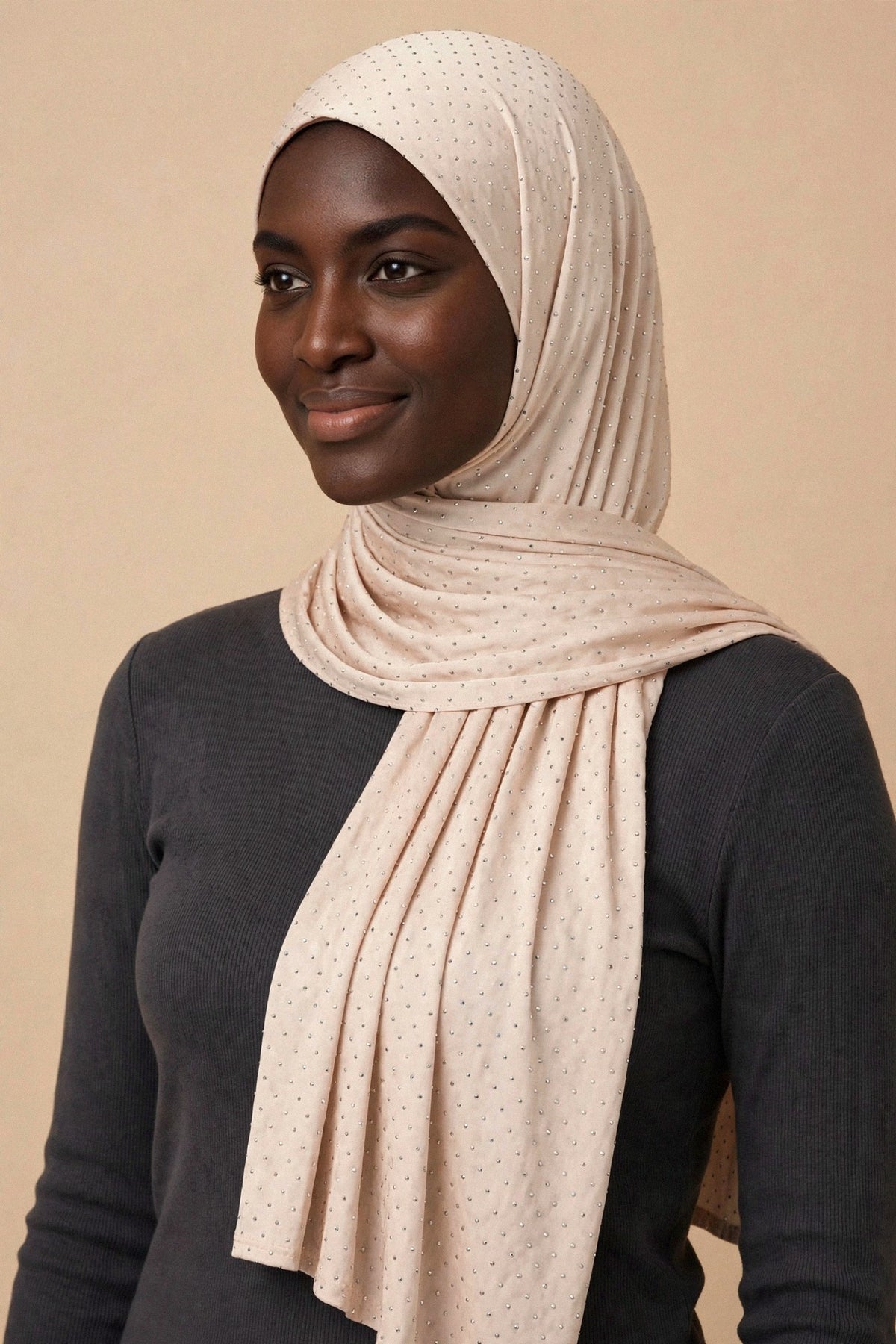 Model wearing the Cream Nude silken diamonds hijab styled with a charcoal top — shown on a different skin tone - Concealed Muslimah