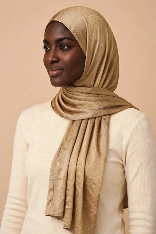 Model wearing the Deep Gold chrome hijab styled with a cream top - Concealed Muslimah