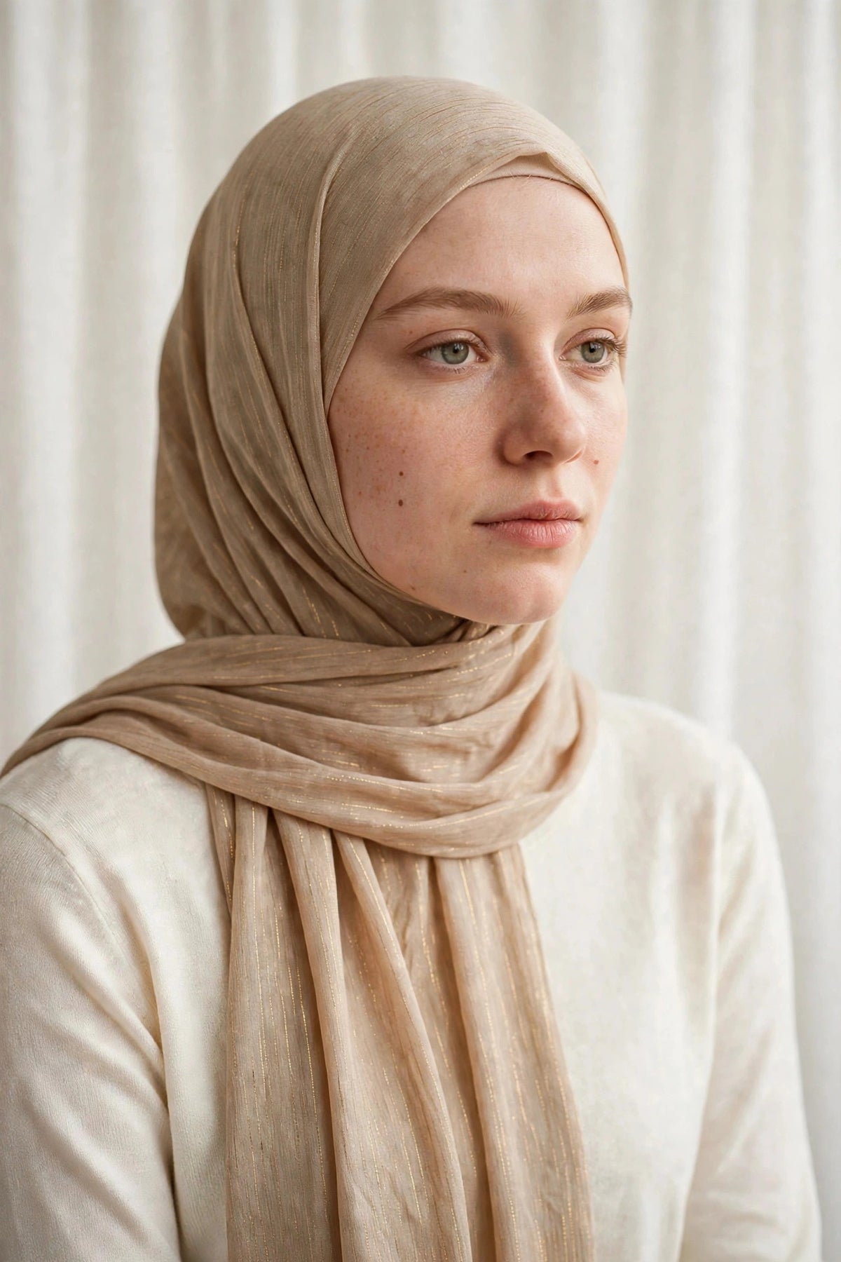 Model wearing the Gold timeless edition hijab styled with a white top - Concealed Muslimah