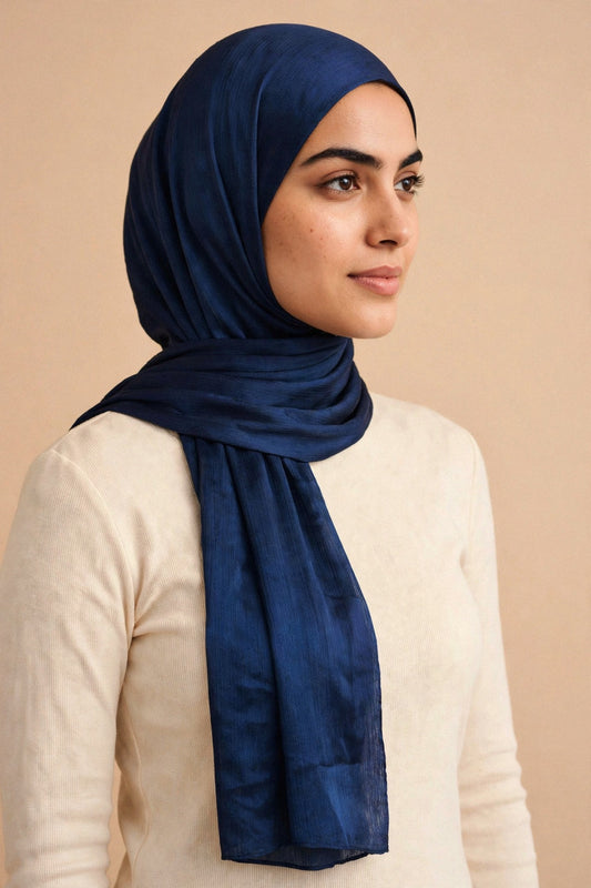 Model wearing the Ink Blue chrome hijab styled with a cream top - Concealed Muslimah