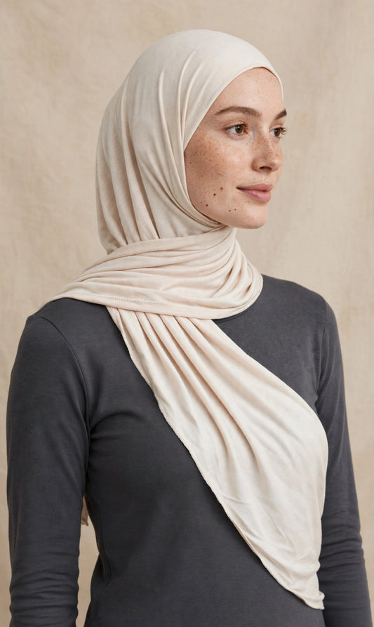 Model wearing the Ivory premium jersey hijab styled with a charcoal top - Concealed Muslimah