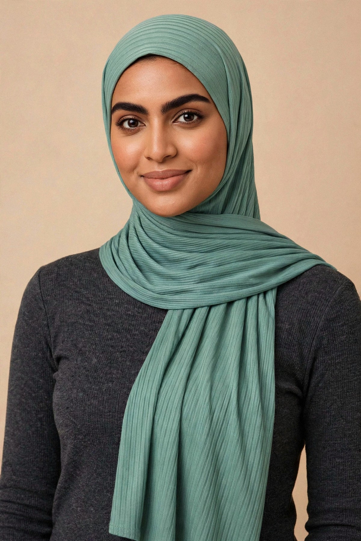 Model wearing the Light Sage ribbed jersey hijab styled with a charcoal top - Concealed Muslimah