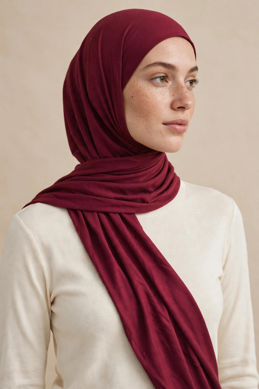 Model wearing the Maroon premium jersey hijab styled with a cream top - Concealed Muslimah