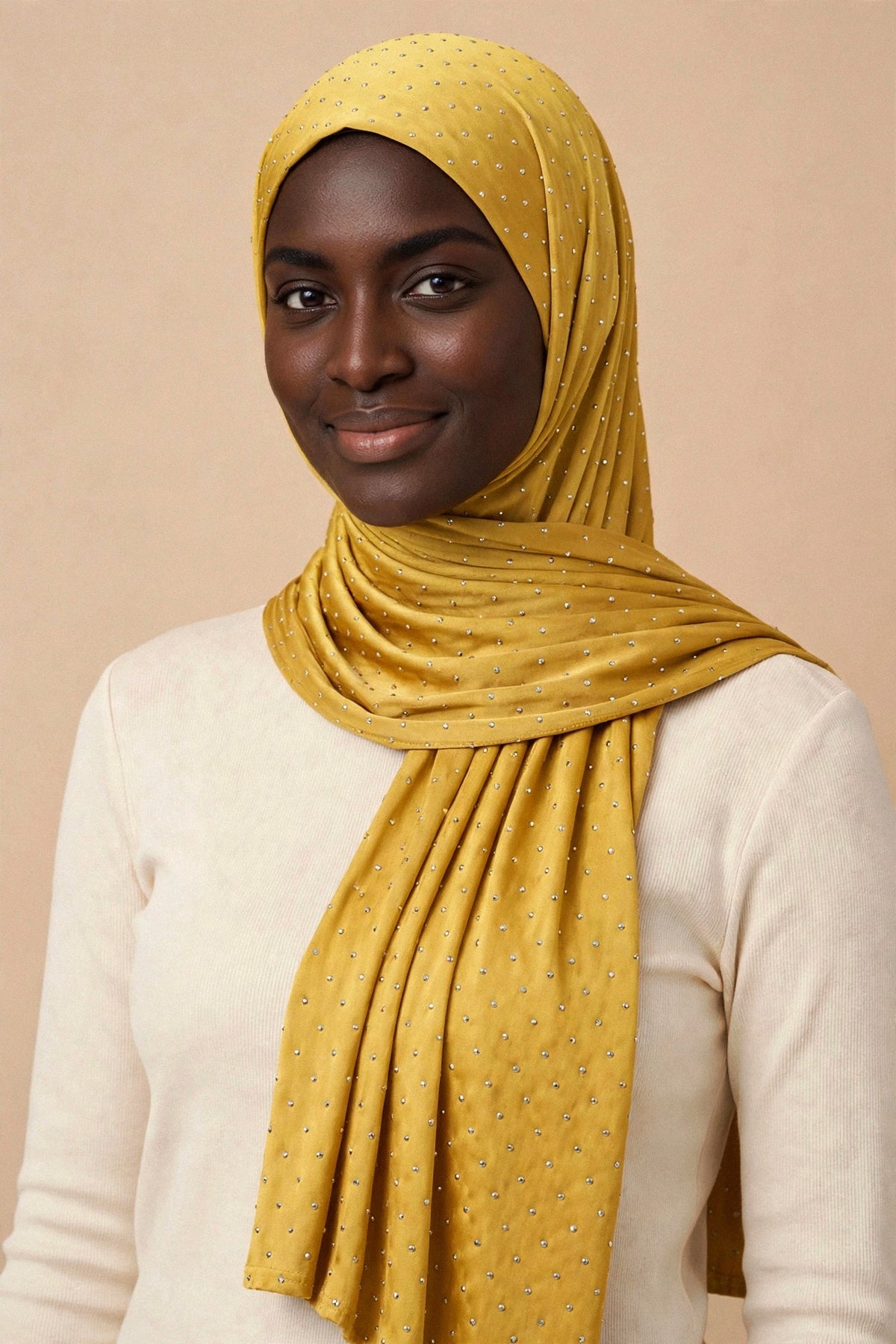 Model wearing the Mustard silken diamonds hijab styled with a cream top - Concealed Muslimah