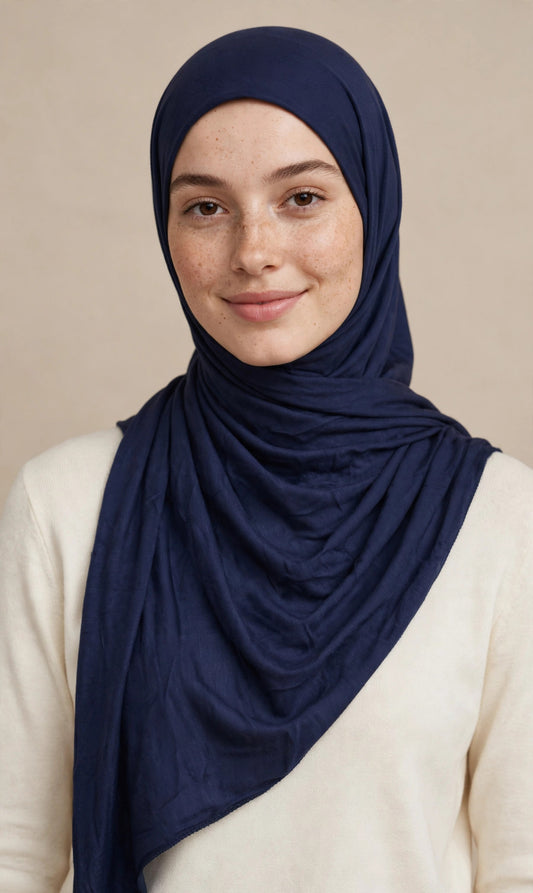 Model wearing the Navy Blue premium jersey hijab styled with a cream top - Concealed Muslimah