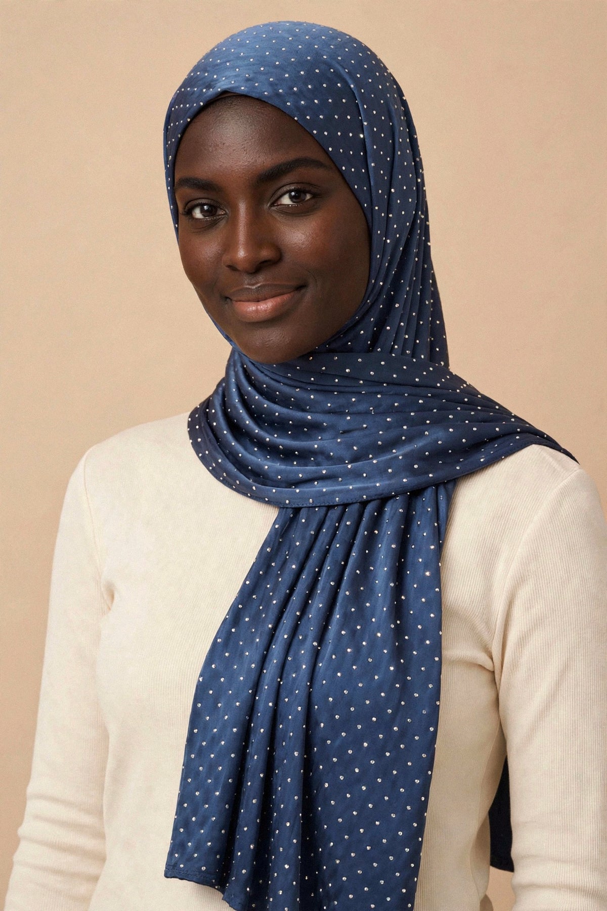 Model wearing the Navy Blue silken diamonds hijab styled with a cream top — shown on a different skin tone - Concealed Muslimah