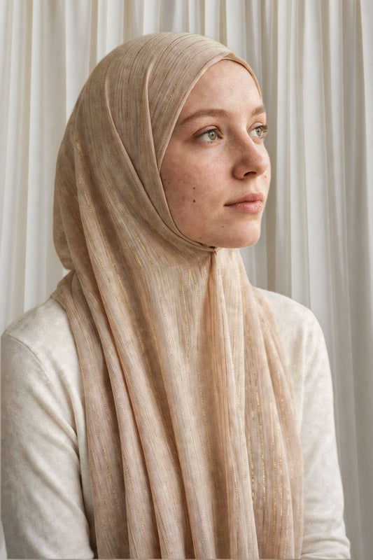 Model wearing the Nude Gold timeless edition hijab styled with a white top - Concealed Muslimah