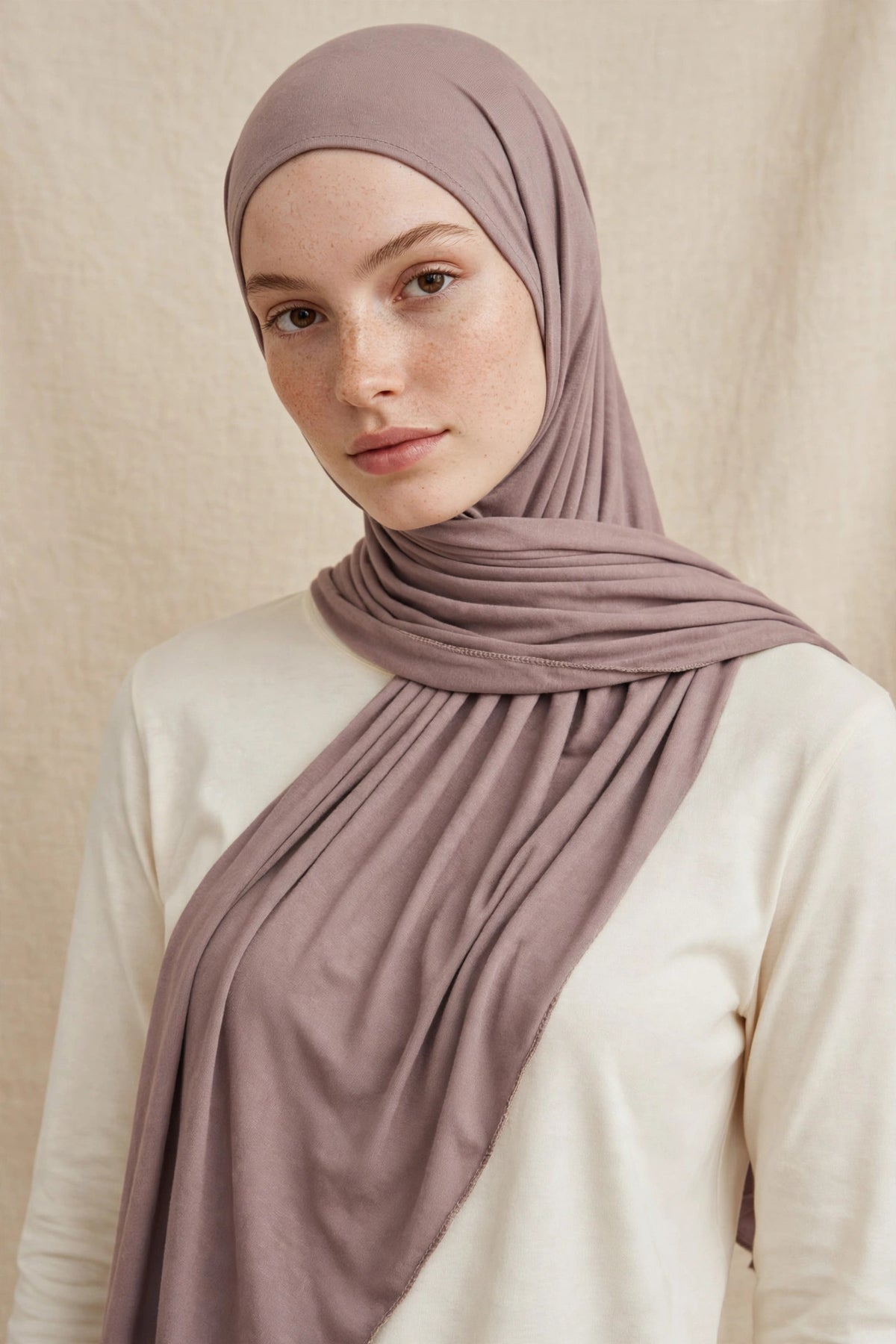 Model wearing the Nude premium jersey hijab styled with a cream top - Concealed Muslimah