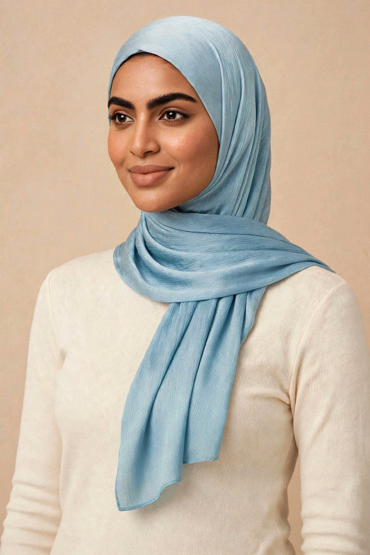 Model wearing the Pastel Blue chrome hijab styled with a cream top - Concealed Muslimah