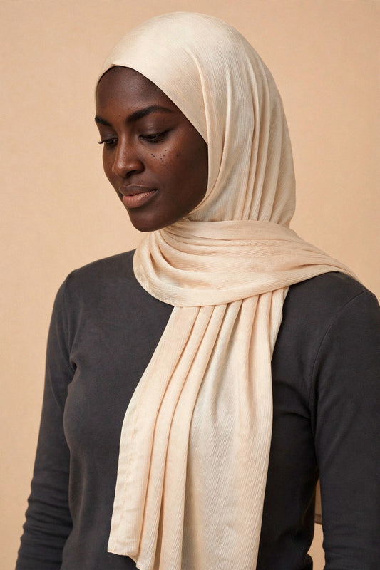 Model wearing the Pearl chrome hijab styled with a charcoal top - Concealed Muslimah
