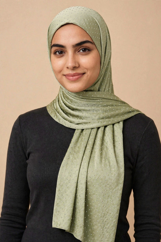 Model wearing the Pistachio silken diamonds hijab styled with a charcoal top - Concealed Muslimah