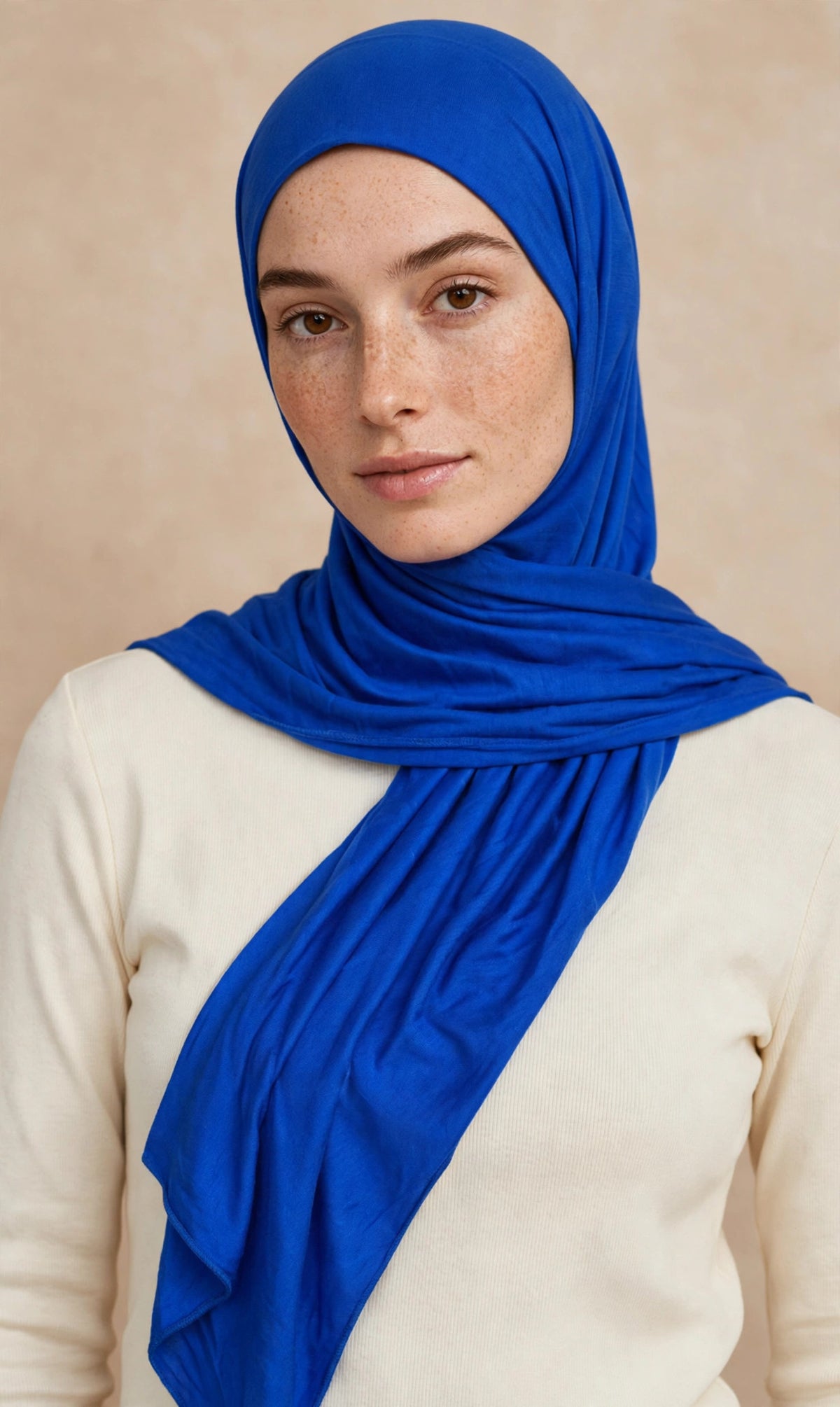 Model wearing the Royal Blue premium jersey hijab styled with a cream top - Concealed Muslimah