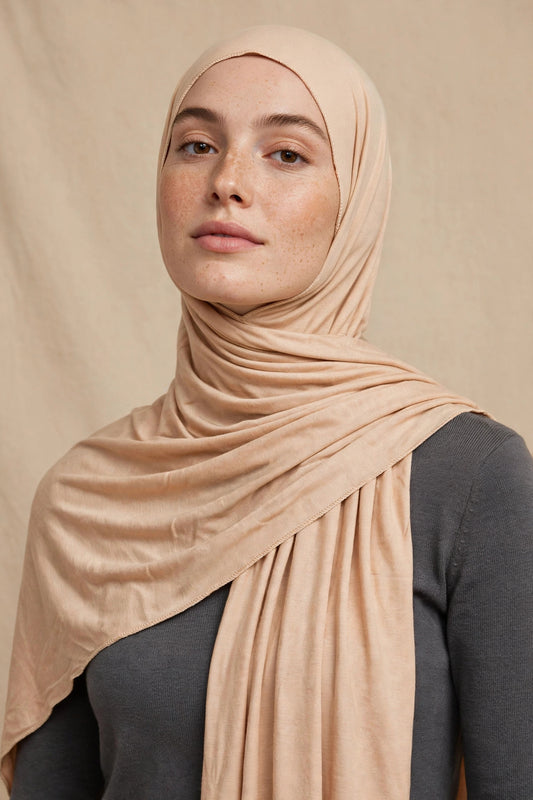 Model wearing the Sahara Desert premium jersey hijab styled with a charcoal top - Concealed Muslimah