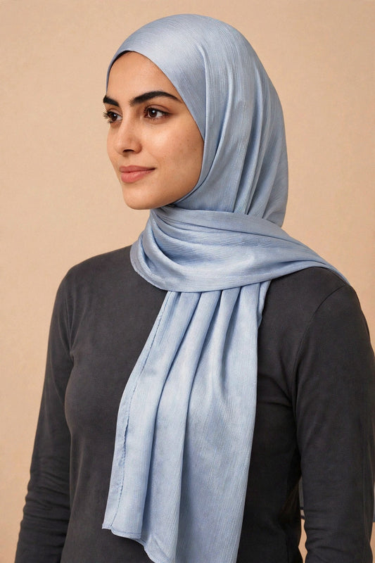 Model wearing the Silver chrome hijab styled with a charcoal top - Concealed Muslimah