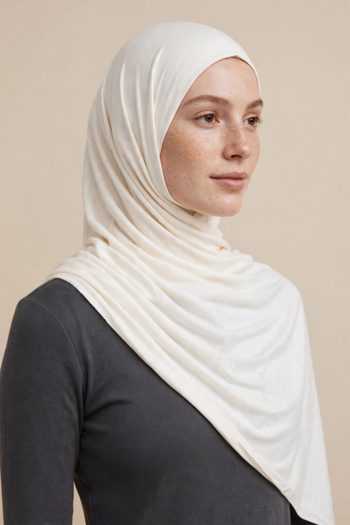 Model wearing the Snow premium jersey hijab styled with a charcoal top - Concealed Muslimah