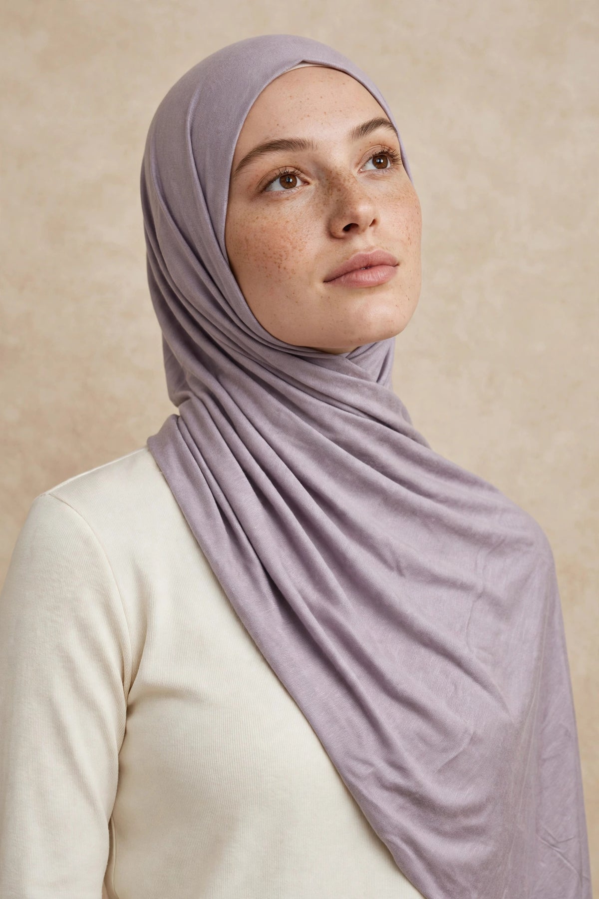 Model wearing the Soft Lilac premium jersey hijab styled with a cream top - Concealed Muslimah