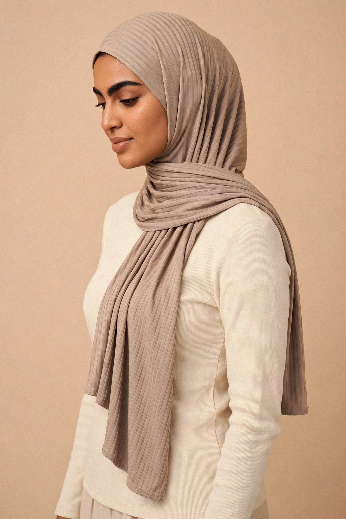Model wearing the Taupe ribbed jersey hijab styled with a cream top - Concealed Muslimah