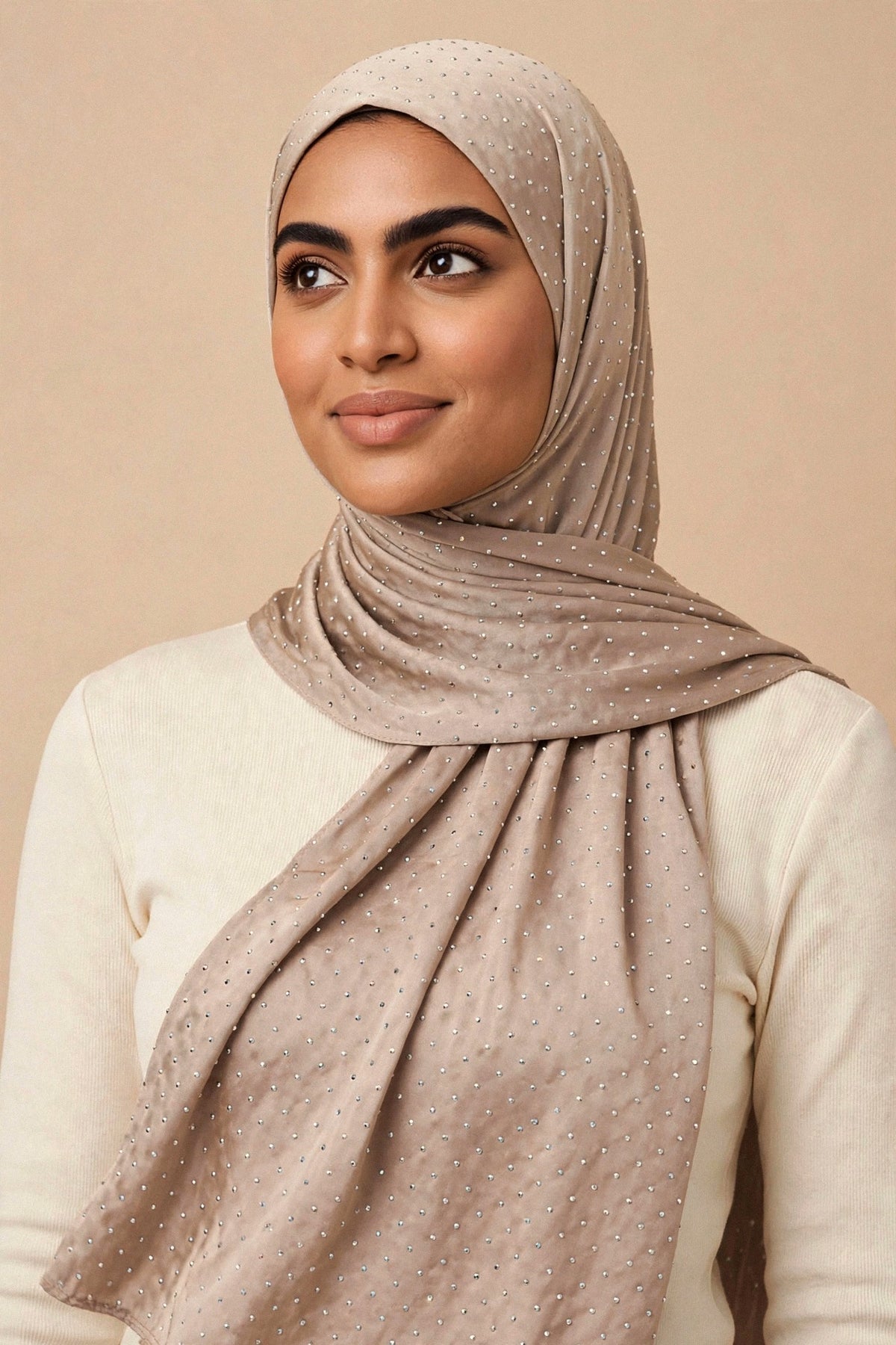 Model wearing the Taupe silken diamonds hijab styled with a cream top — shown on a different skin tone - Concealed Muslimah