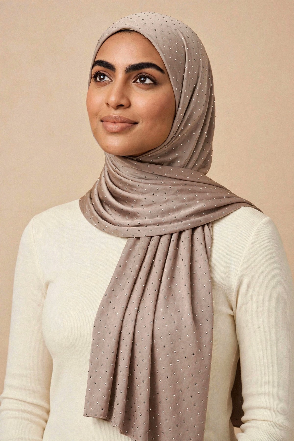 Model wearing the Taupe silken diamonds hijab styled with a cream top — shown on a different skin tone - Concealed Muslimah