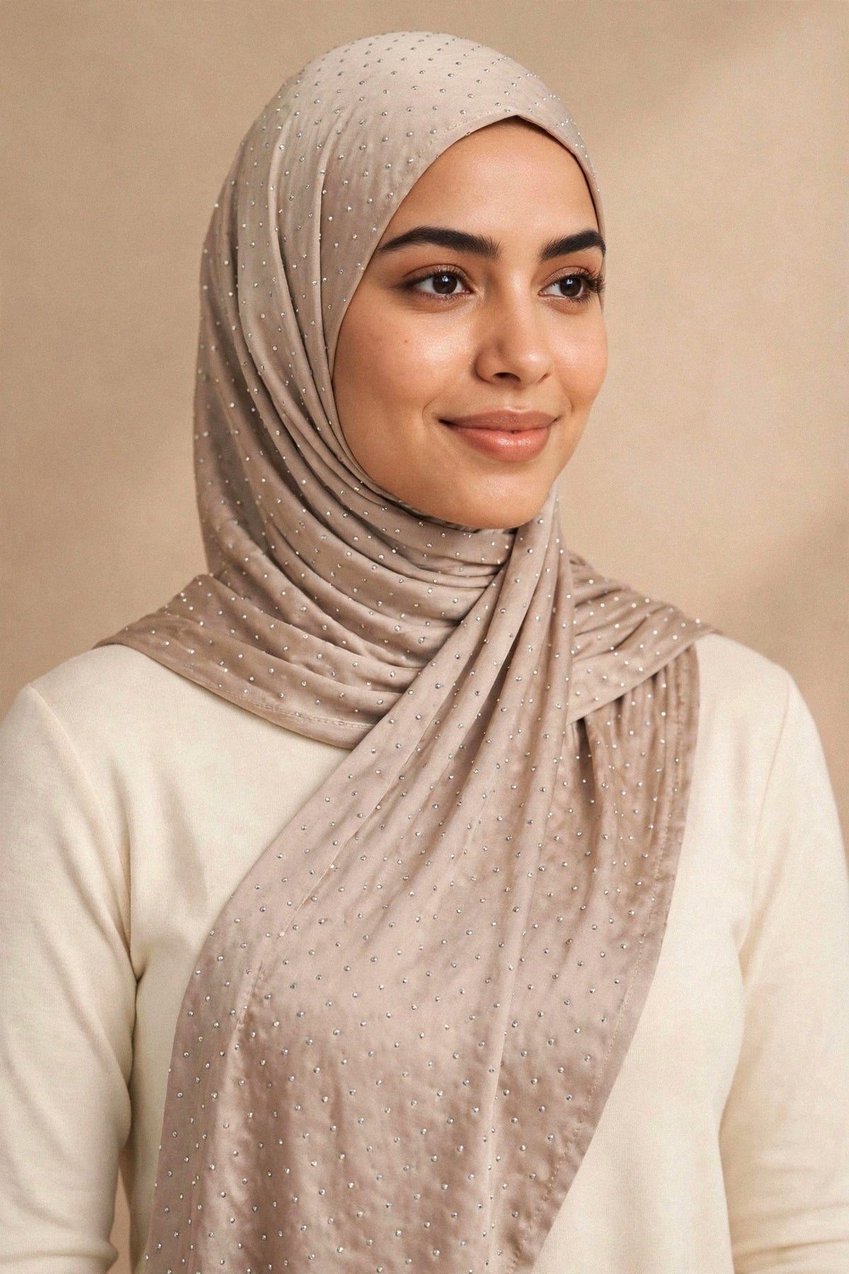 Model wearing the Taupe silken diamonds hijab styled with a cream top - Concealed Muslimah