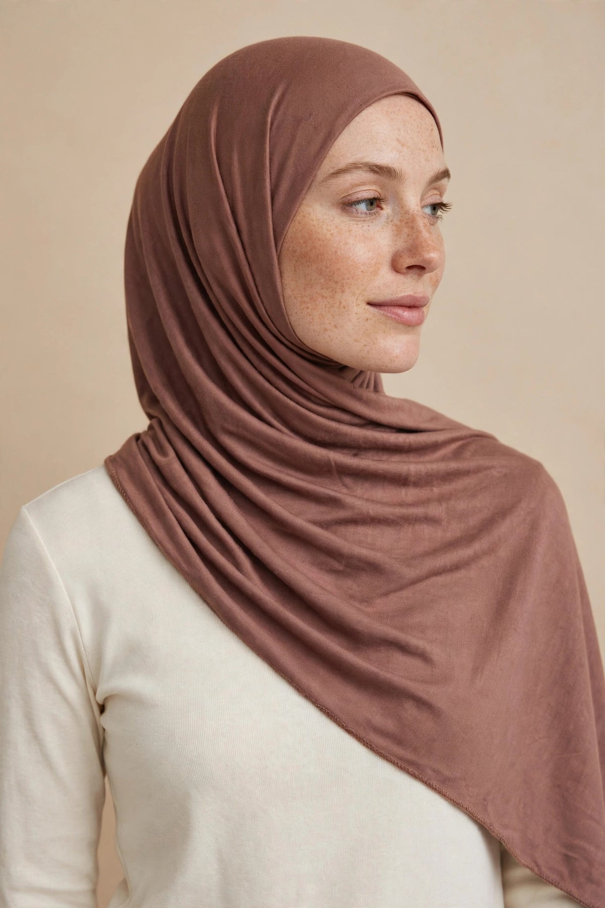 Model wearing the Terracotta premium jersey hijab styled with a cream top - Concealed Muslimah