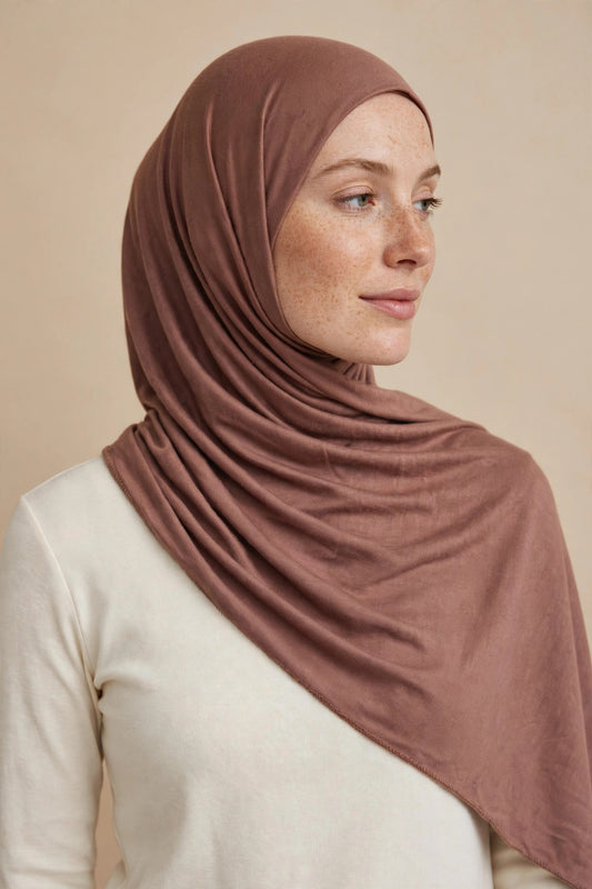 Model wearing the Terracotta premium jersey hijab styled with a cream top - Concealed Muslimah