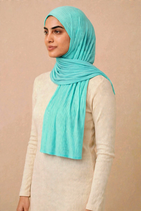 Model wearing the Turquoise ribbed jersey hijab styled with a cream top - Concealed Muslimah