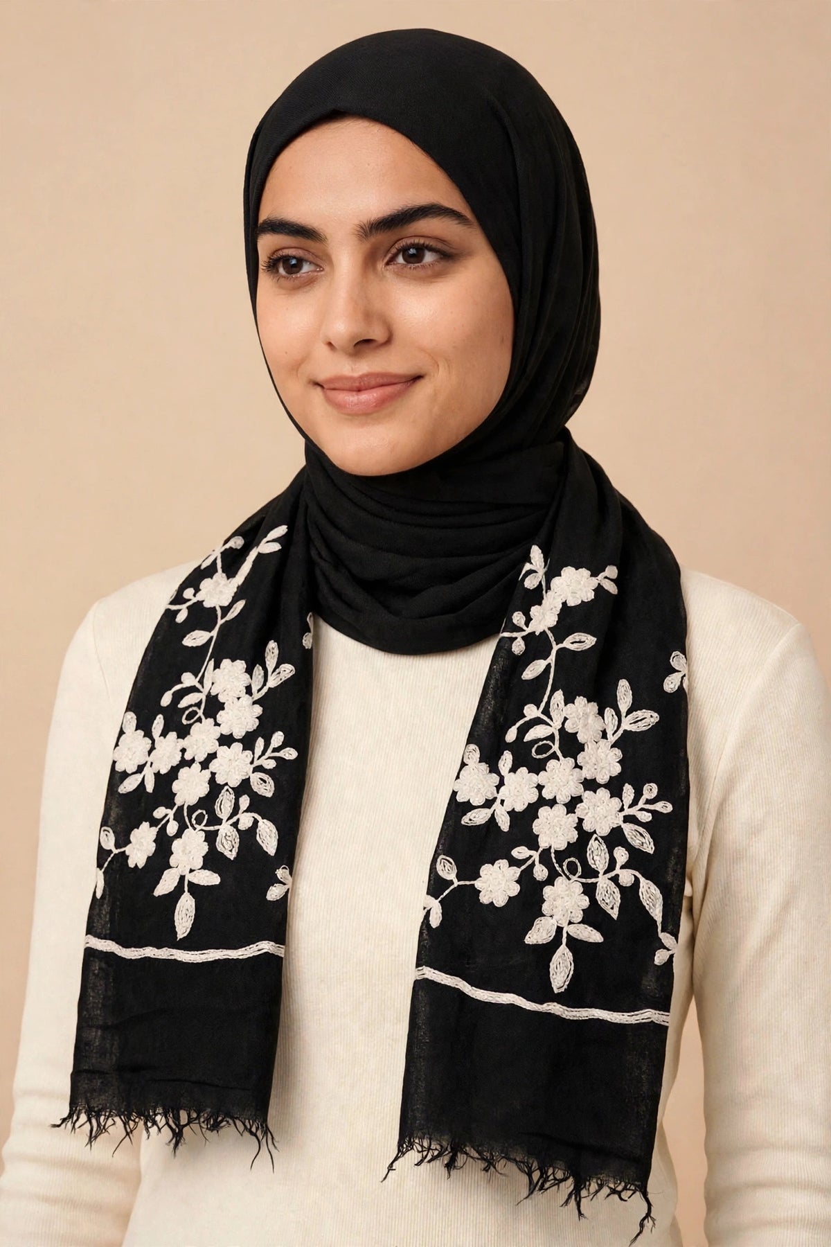 Model wearing the Wildflower hijab — black viscose with white floral embroidery on both ends